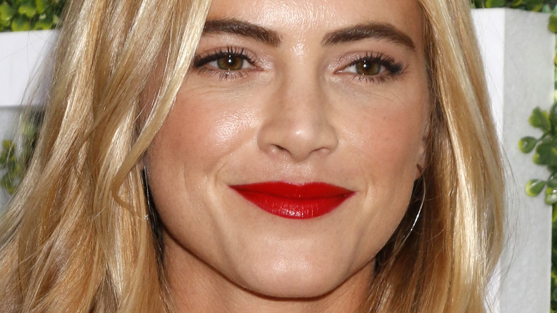 Emily Wickersham rocks a red lip on the red carpet