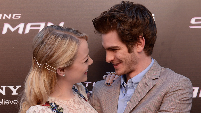 Andrew Garfield and Emma Stone glancing