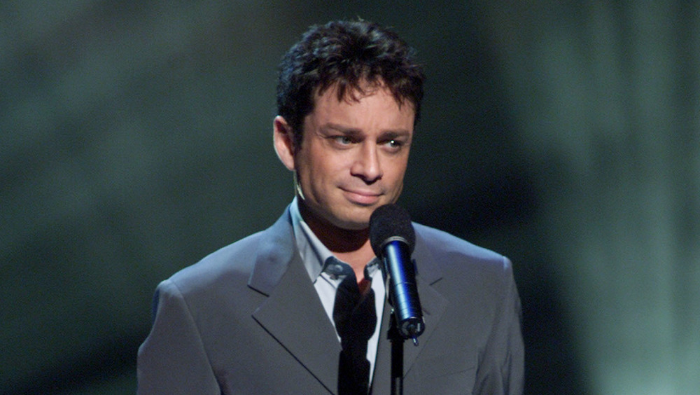 Chris Kattan furrowing his brow onstage