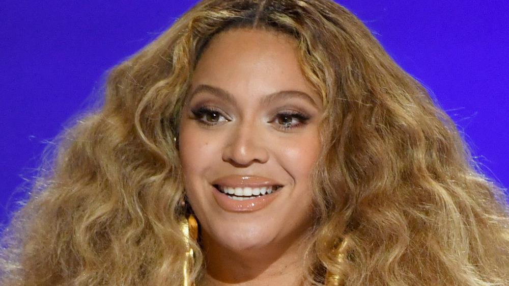 Beyoncé smiling onstage at the 2021 Grammys