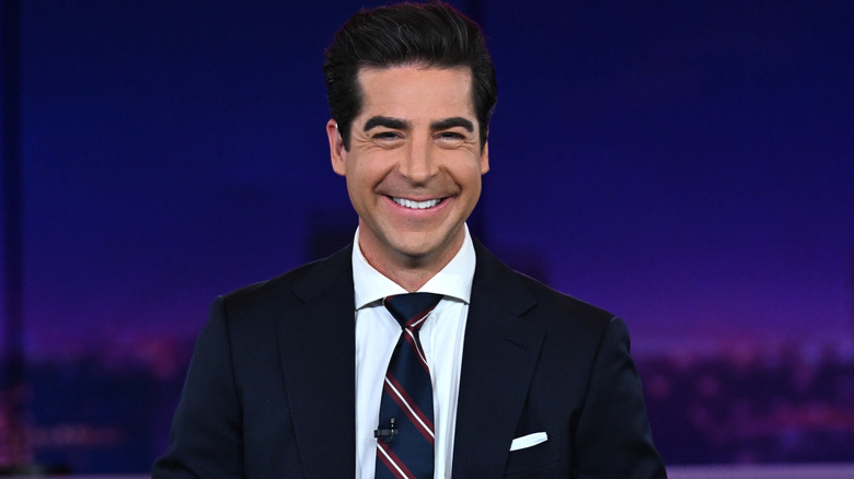 Jesse Watters smiling on the set of his show