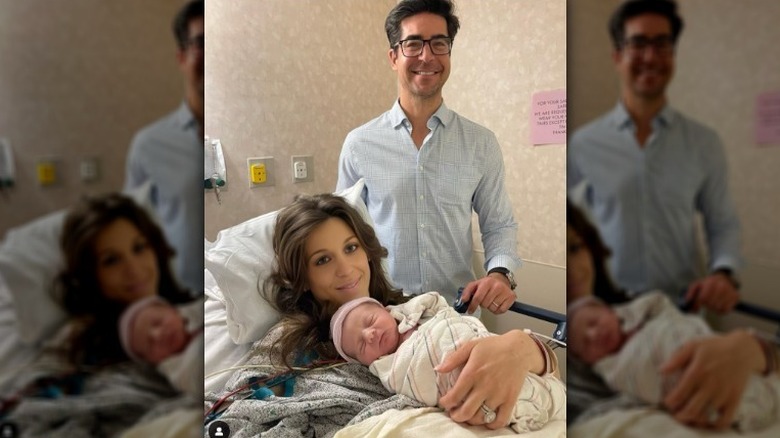 Jesse Watters posing with his wife and newborn