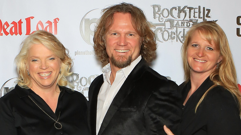 Janelle, Kody, and Christine Brown smiling at red carpet event