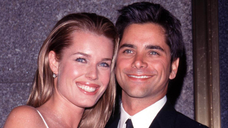 Rebecca Romijn and John Stamos smiling