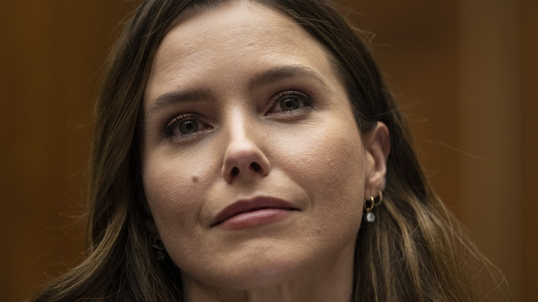 Sophia Bush smiling, wearingdiamond earrings