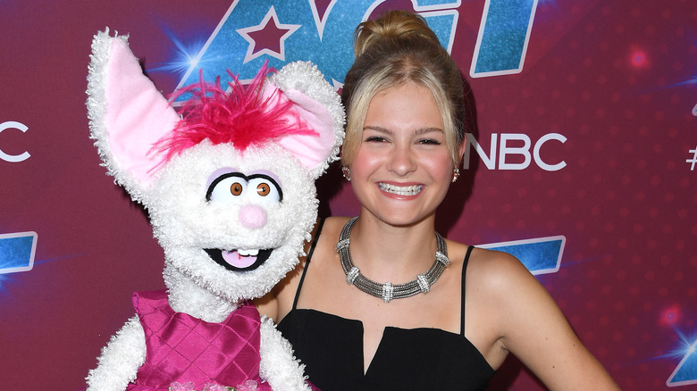 Darci Lynne Farmer posing with rabbit puppet