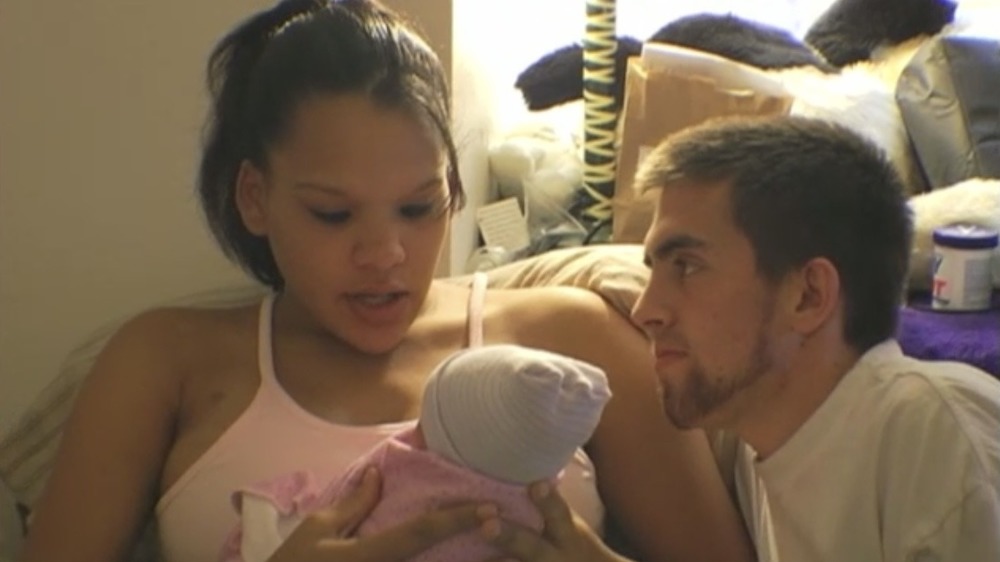 Ebony Jackson and Joshua Rendon filming with their infant