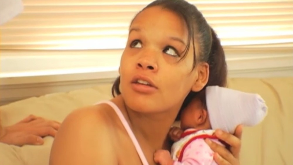 Ebony Jackson cradling her infant