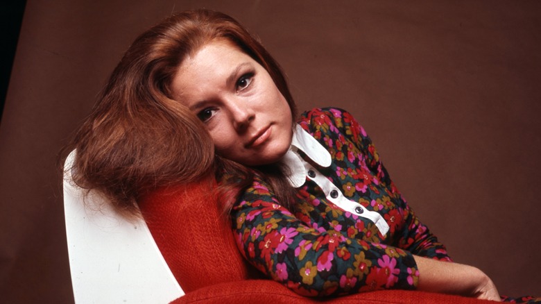 Diana Rigg posing on chair