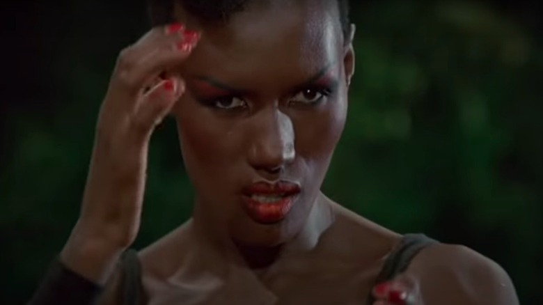 Grace Jones looking fierce, hand placed at temple