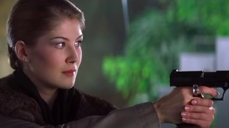 Rosamind Pike holding a gun