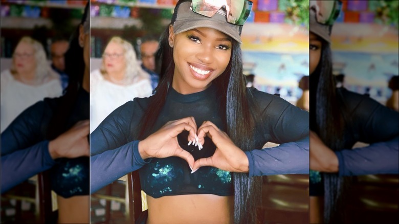 Faith Stowers making heart with hands