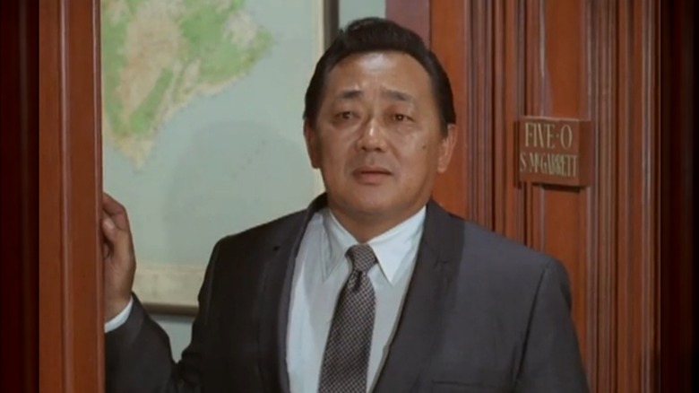 Kam Fong Chun standing in a doorway while filming "Hawaii Five-O."