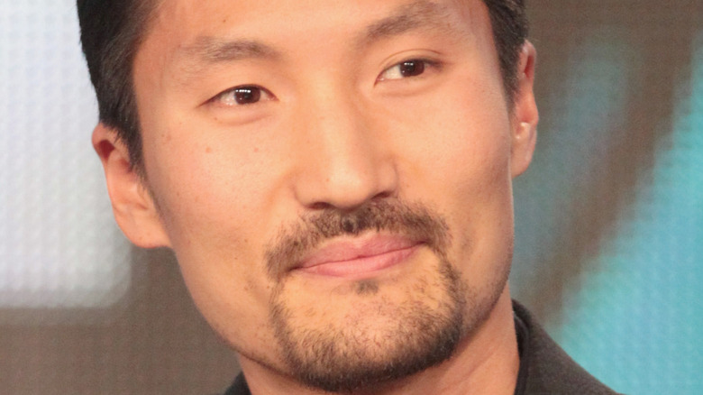 Yul Kwon half smile 