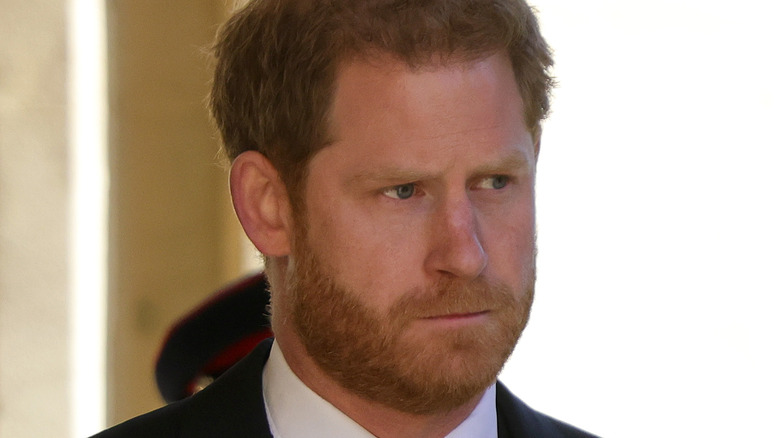 Prince Harry looks to side