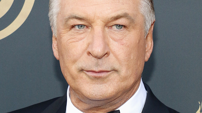 Alec Baldwin with serious expression on red carpet