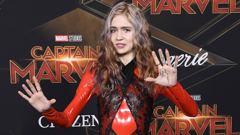 Grimes posing on red carpet