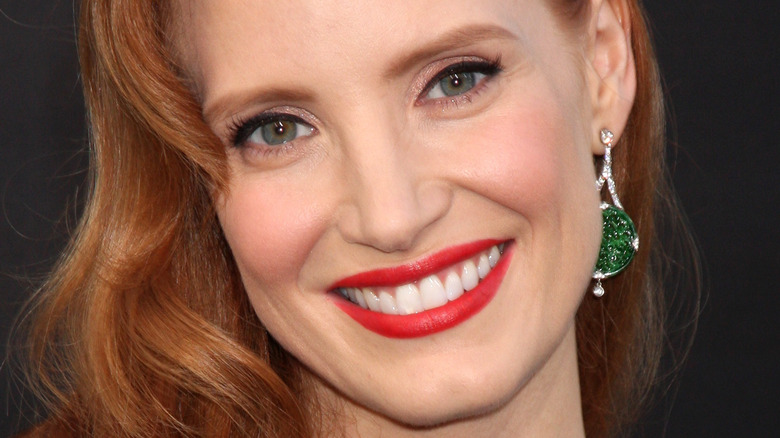 Jessica Chastain with wide smile and red lipstick 