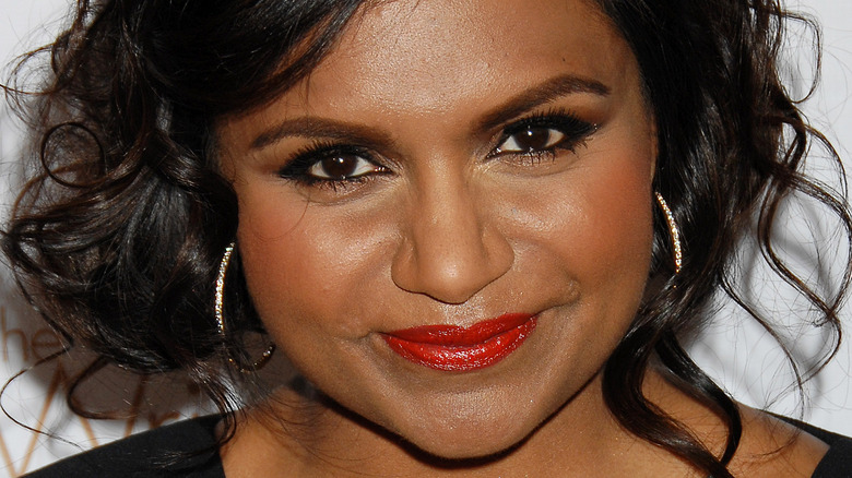 Mindy Kaling donning red lipstick on the red carpet