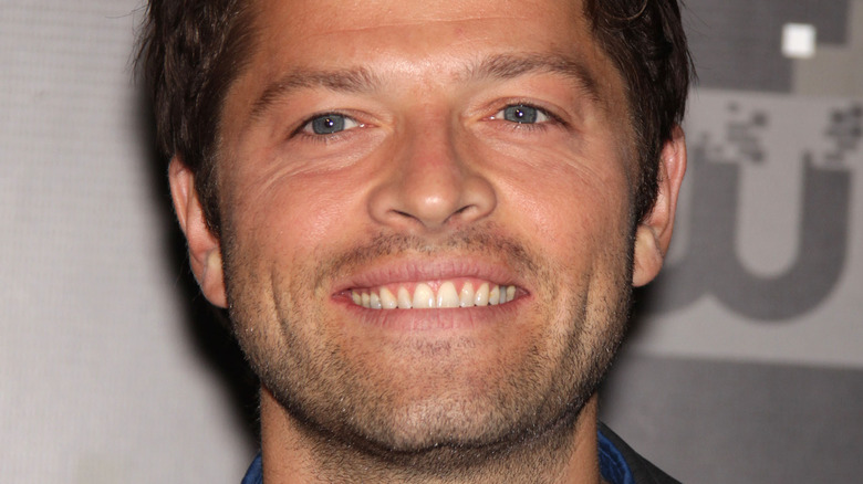 Misha Collins smiles on red carpet