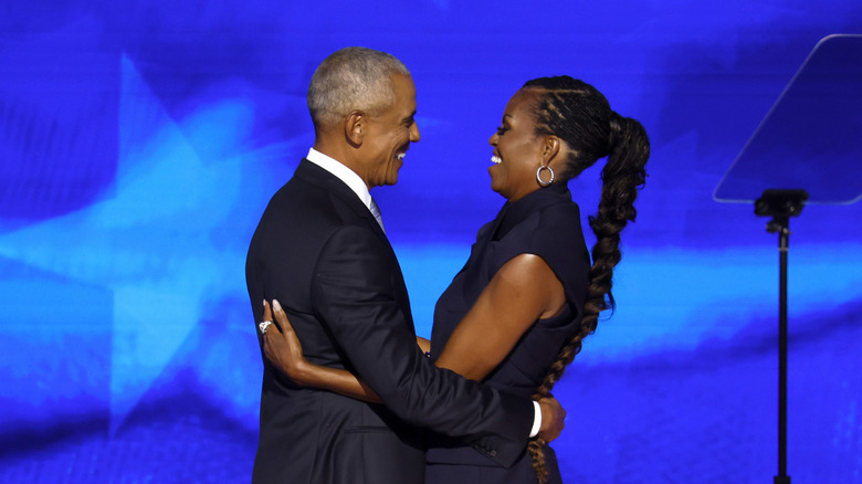 Barack and Michelle hugging onstage