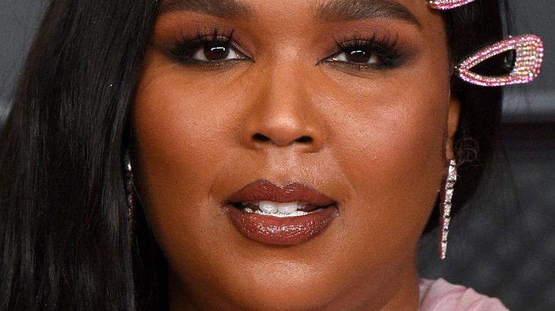 Lizzo wears a pink outfit at an event