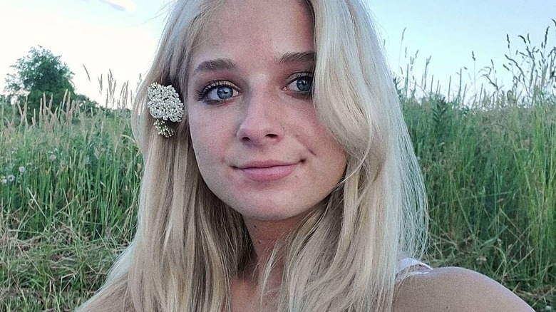 Jackie Evancho with flower tucked behind ear