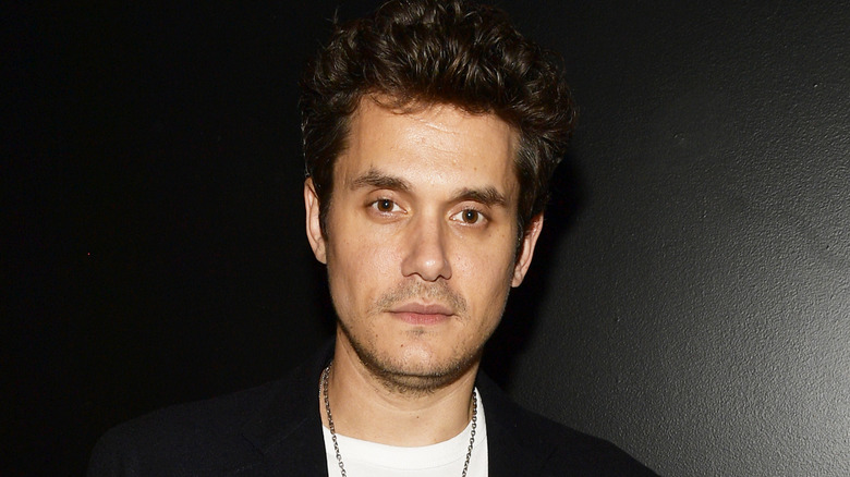 John Mayer posing for pictures
