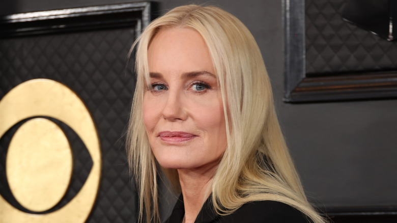 Daryl Hannah posing at an awards show with her hair down and straight.