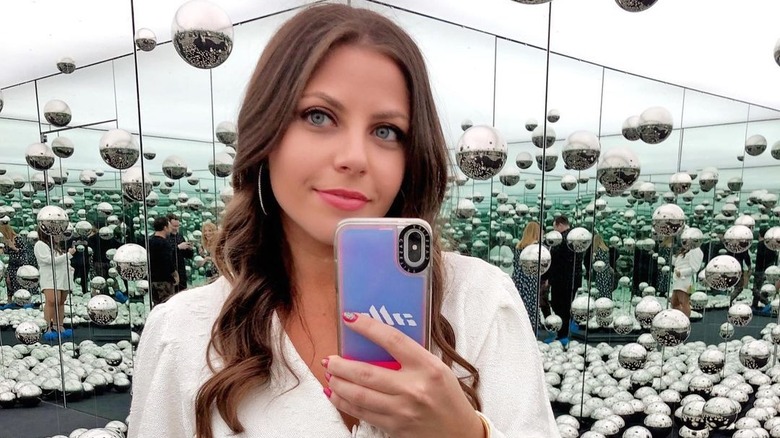 Ally Shapiro taking selfie with silver spheres