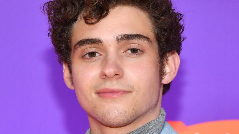 Joshua Bassett smiling on red carpet