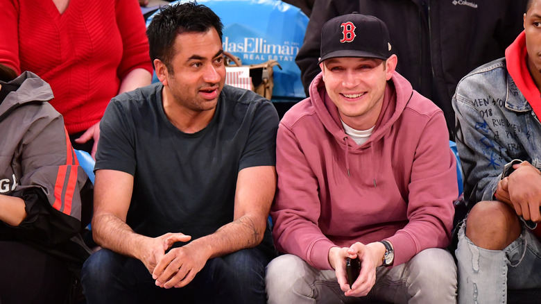 Kap Penn watching a basketball game with his partner, Josh