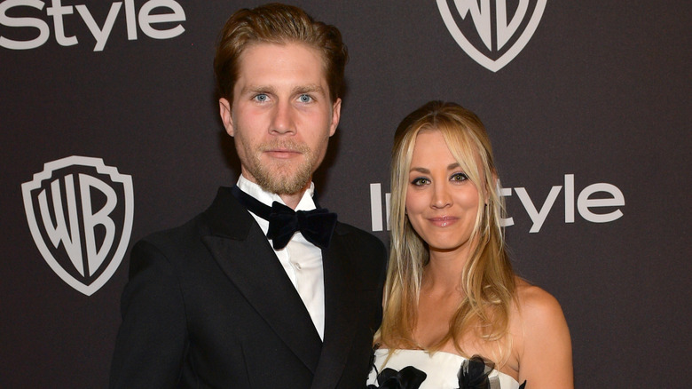 Karl Cook wearing a black tuxedo and bow tie with Kaley Cuoco wearing a strapless white and black gown