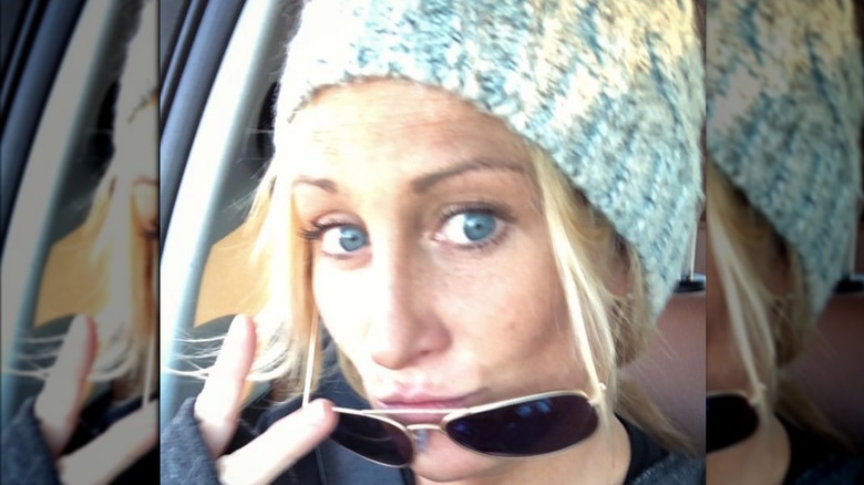 Kat Held, 2018 car selfie, wearing a beanie and sunglasses pulled down