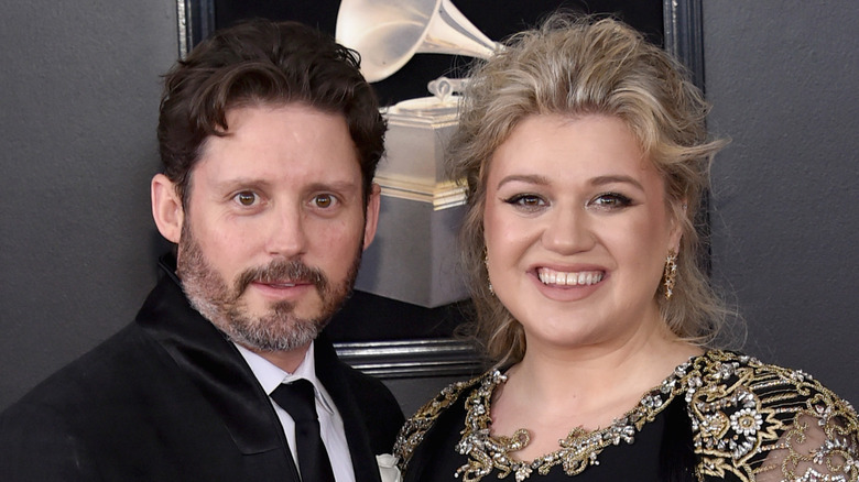 Brandon Blackstock and Kelly Clarkson smiling and posing together