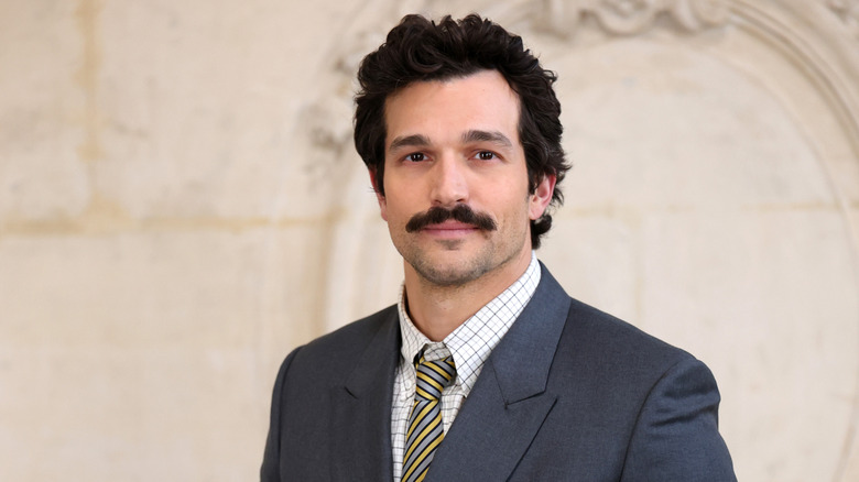 Paul Anthony Kelly mustache, suit and tie