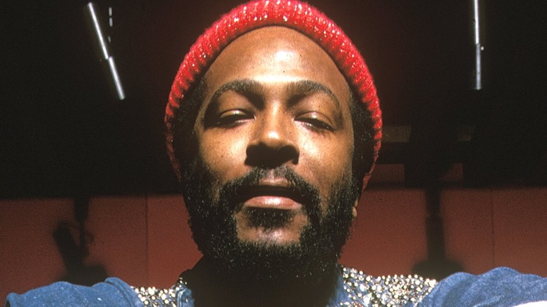 Marvin Gaye wearing a red hat