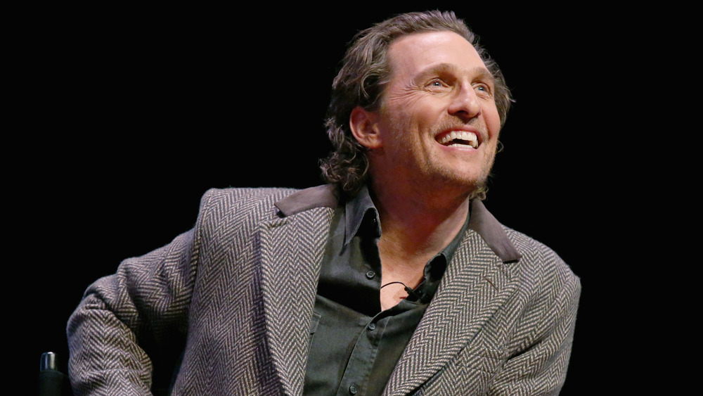 Matthew McConaughey smiling and looking up