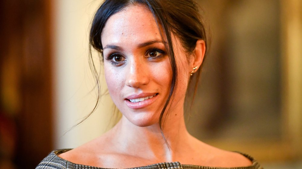 Meghan Markle chats with people inside the Drawing Room during a visit to Cardiff Castle