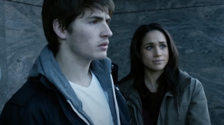 Gregg Sulkin and Meghan Markle looking concerned
