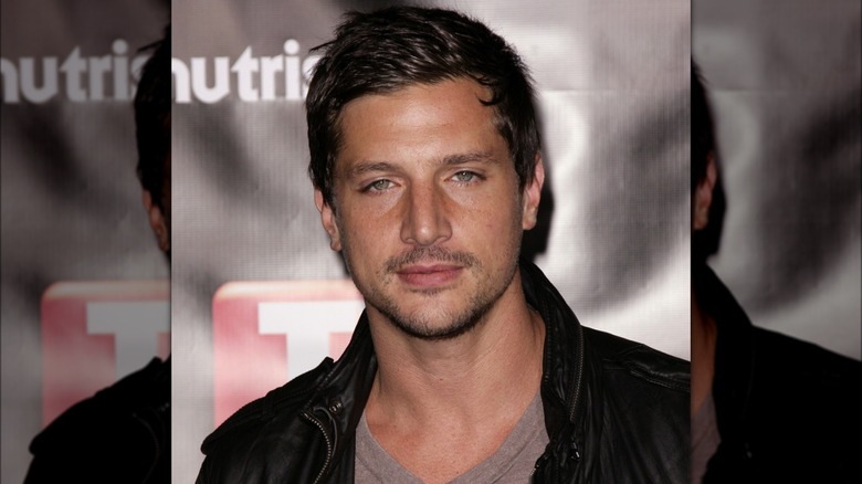 Simon Rex with a serious expression