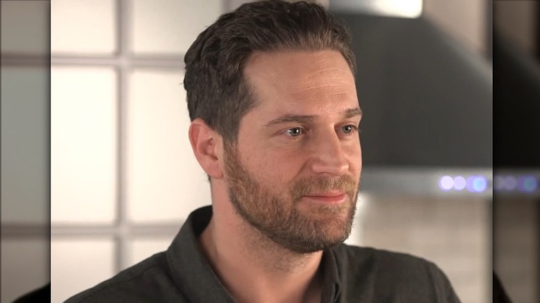 Cory Vitiello with lips pressed together and looking off-camera