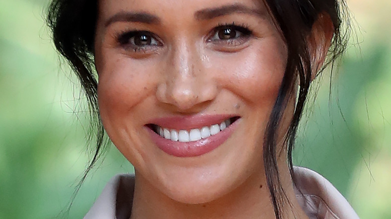 Meghan Markle smiling with updo