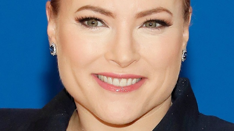 Meghan McCain smiling with blue earrings