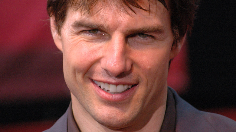 Tom Cruise head down grinning