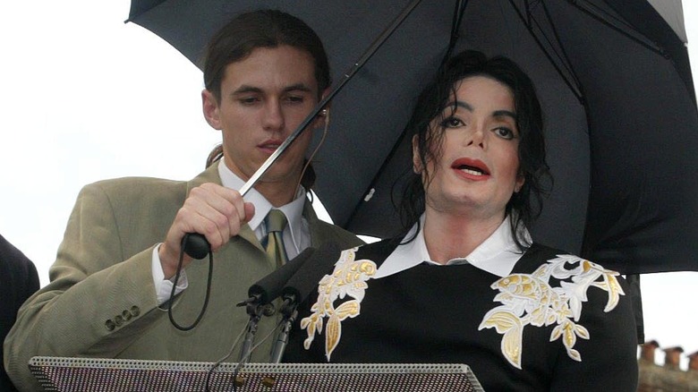 Matt Fiddes holding umbrella for Michael Jackson
