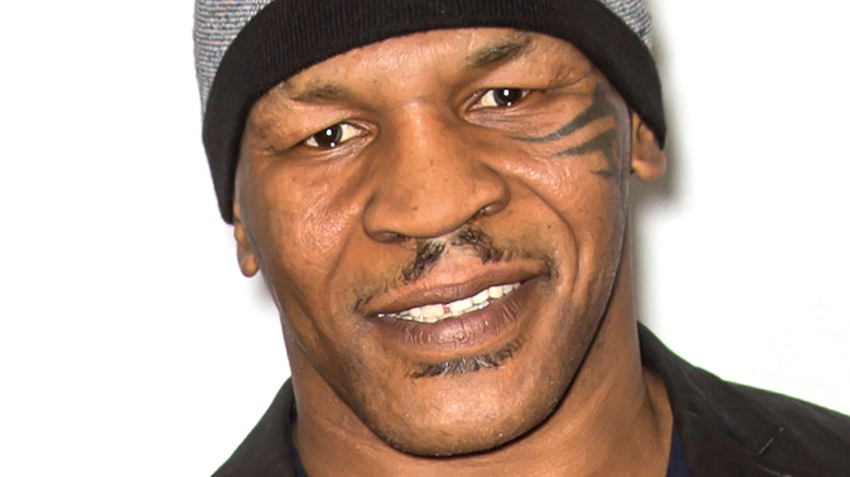 Mike Tyson smiling goatee beanie cap