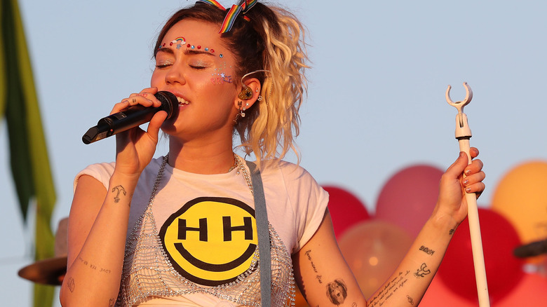 Miley Cyrus singing into a mic