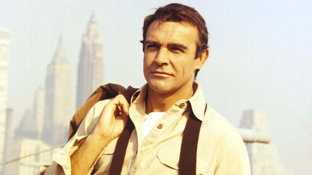 A young Sean Connery gazing off into the distance with his jack slung over his shoulder
