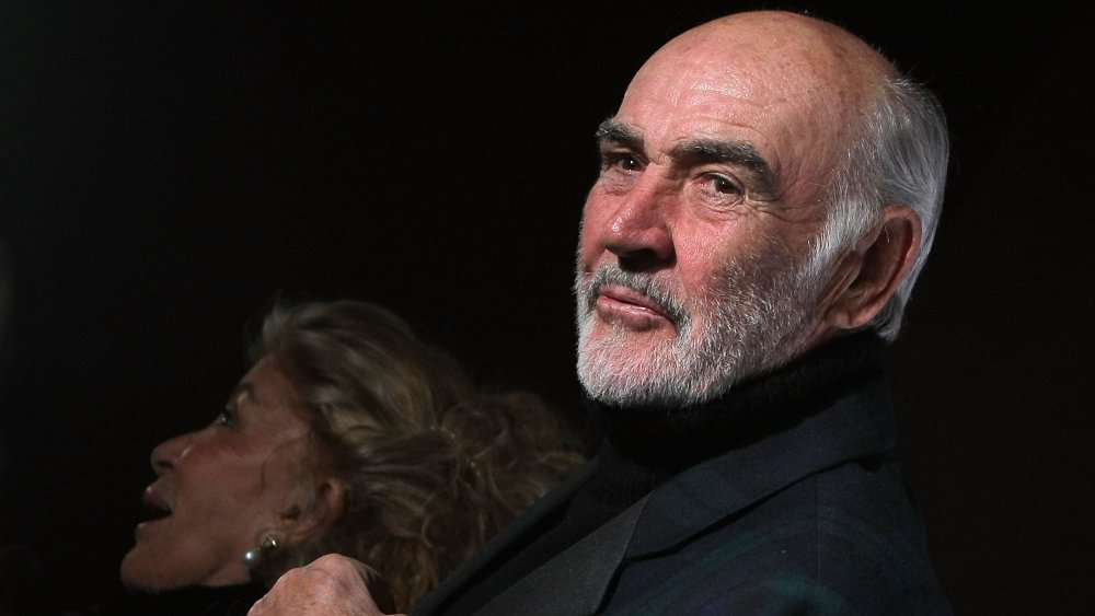 Sean Connery and his wife attending a fashion show in 2009